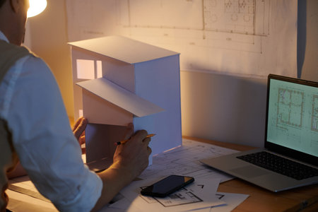 Architect making model of house out of paper