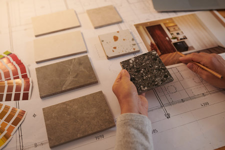 Interior designer choosing samples of floor tiles for project