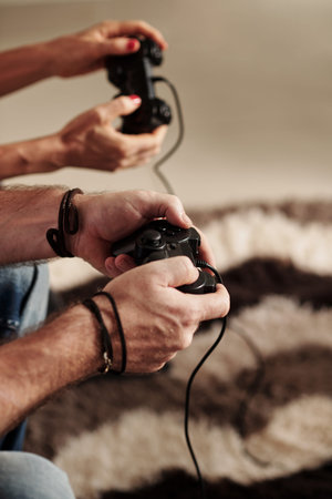 Closeup image of mature couple playing video game at home