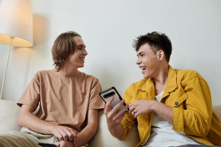 Happy young men laughing at meme they found on social mediaの写真素材