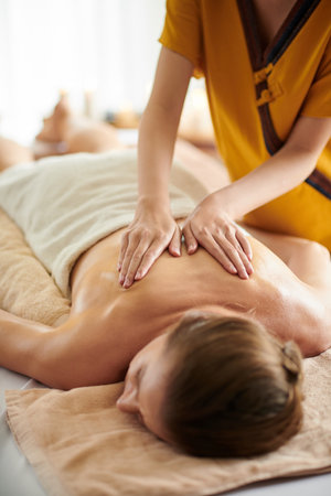 Cropped image of woman getting back massage with oils in beauty salonの写真素材