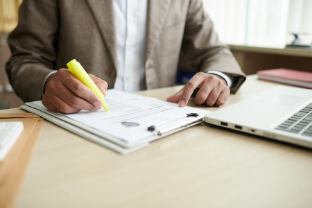 Businessman highlighting important information in cv of job application