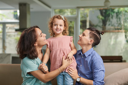 Happy proud mothers looking at adorable daughter telling poem she learnt for event
