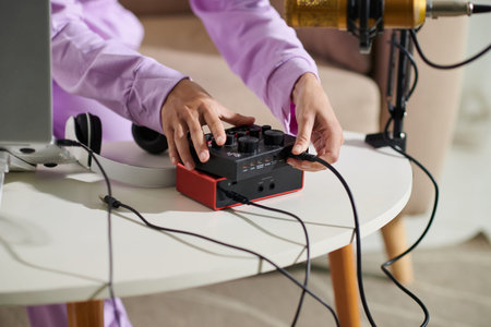 Closeup image of teenage girl setting mike and camera to record video at home