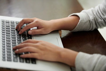 Hands of woman typing on keyboard, freelancing and studying online conceptの写真素材