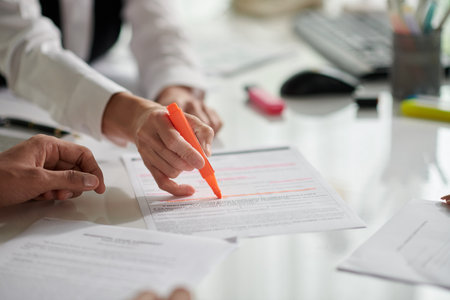 Insurance agent highlighting important details in agreementの写真素材