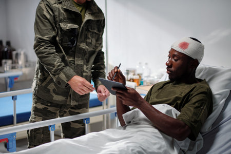 Segeant asking soldier to sign document on tablet computerの写真素材