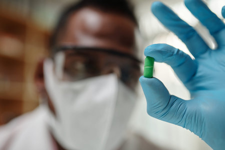 Closeup image of scientist showing pill with new innovative medicine he invented