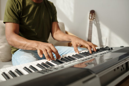 Hands of talented man playing synthesizer when working on new songの写真素材