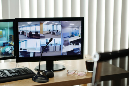 Monitors translating video from surveillance cameras in officeの写真素材