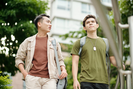 Friends walking on college campus and discussing homework