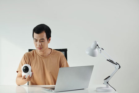 Man installing application for surveillance camera on laptop