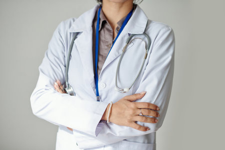 Cropped image of confident general practitioner in white labcoat crossing armsの写真素材