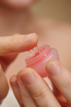 Woman applying sleep pink lip sleeping maskの写真素材