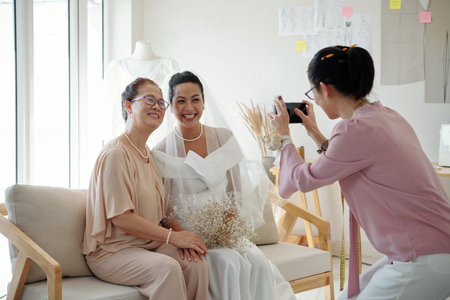 Bride and her mother posing for photo in fashion atelierの写真素材