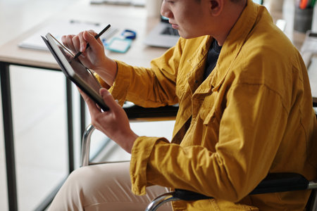 Creative designer drawing sketch on tablet computer when working in officeの写真素材