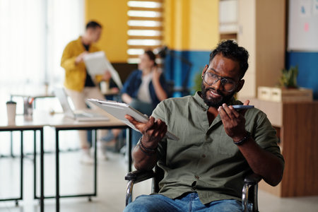 Portrait of entrepreneur recording voice message for coworker after analyzing chartの写真素材
