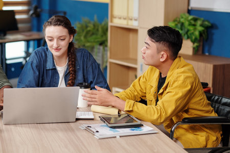 Businessman suggesting ideas at meeting with colleaguesの写真素材