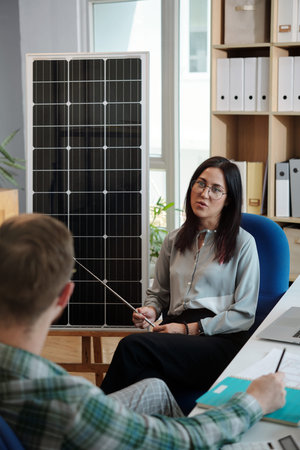 Solar energy sales manager talking to client explaing advantages of having solar panels