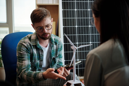 Project manager discussing wind turbine characteristicsの写真素材