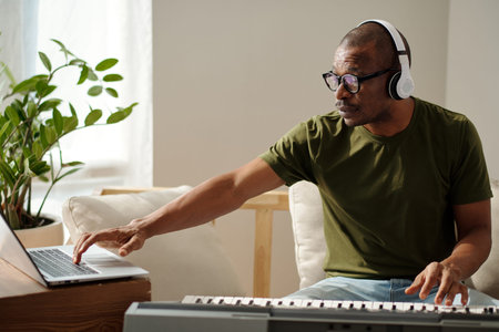 Musician in headphones recording new music track for his album