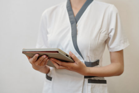 Spa salon receptionist checking schedule on tablet computerの写真素材