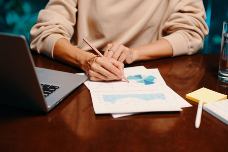 Hands of marketing manager analyzing report with research dataの写真素材