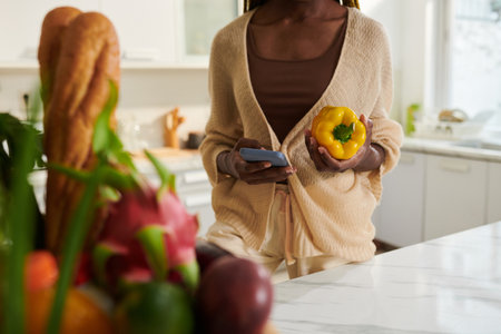 Woman making new order of fresh groceries via mobile appの写真素材