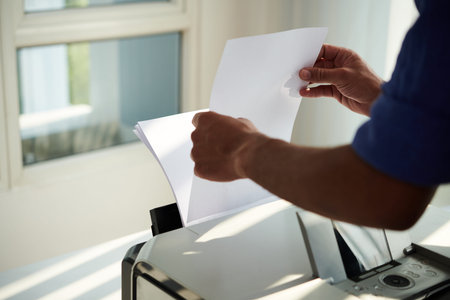 Office worker printing documents for meeting