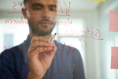 Marketing manager writing ideas for business development on glass wallの写真素材