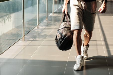 Cropped image of sportsman with gym bag walking to fitness centerの写真素材