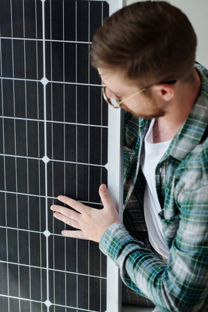 Man checking if solar panel is not damaged after deliveryの写真素材
