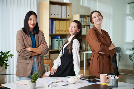 Portrait of successful business team of women smiling at camera standing in officeの写真素材