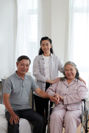 Portrait of smiling senior parents and adult daughter at home