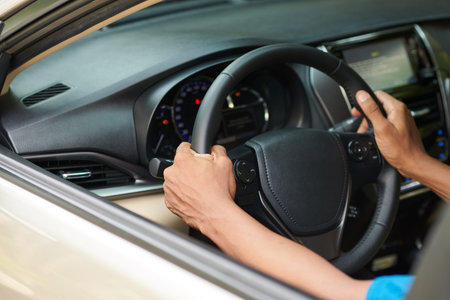 Closeup image of driver turning steering wheel
