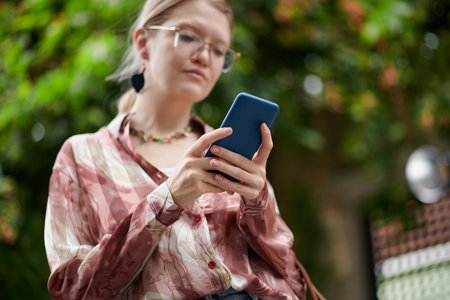 Young woman ordering taxi car via application on smartphoneの写真素材