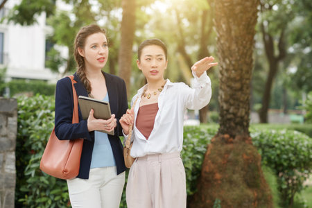 Real estate managers visiting new district, discussing its location and advantagesの写真素材