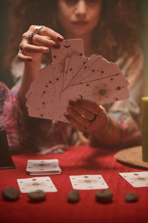 Forture teller looking at tarot cards in her hands whenの写真素材