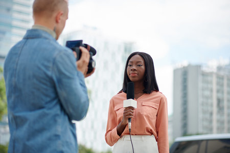 Cameraman and journalist filming news storyの写真素材
