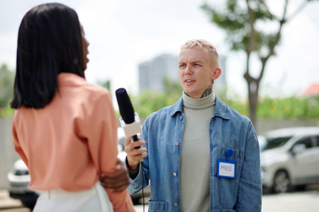 Frowning press representative talking to woman in the street
