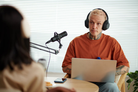 Blogger with laptop recording podcast with famous person
