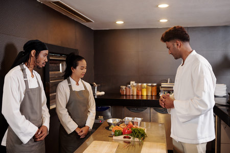 Chef asking cooks to chop and stew vegebales for his