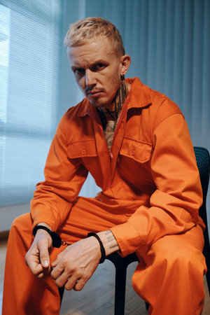 Portrait of arrested on suspicion of murder waiting for imprisonmentの写真素材