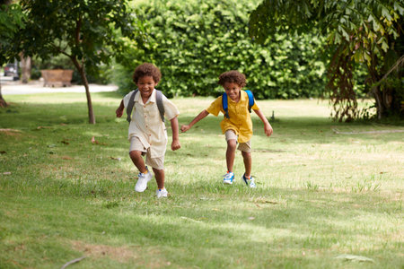 Joyful kids running on school backyard on sunny dayの写真素材