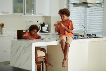 Children playing with colorful clay moulding at homeの写真素材