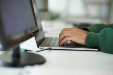 Closeup image of programmer working on computer in office of it company