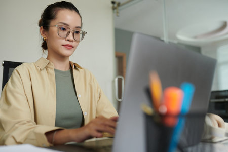Concentrated devops engineer in glasses deploying updatesの写真素材