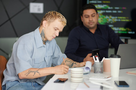 Creative UI designer working on wireframe of new website at office deskの写真素材