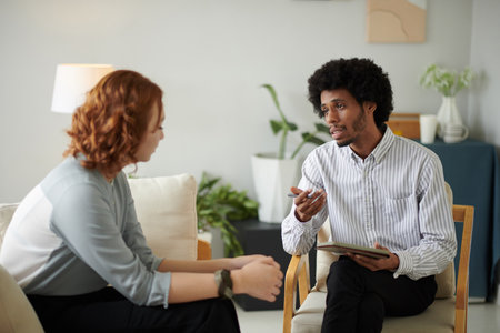 Counselor talking to client about her stressful workの写真素材