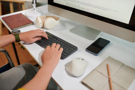 Cropped image of programmer reviewing code on computer screenの写真素材